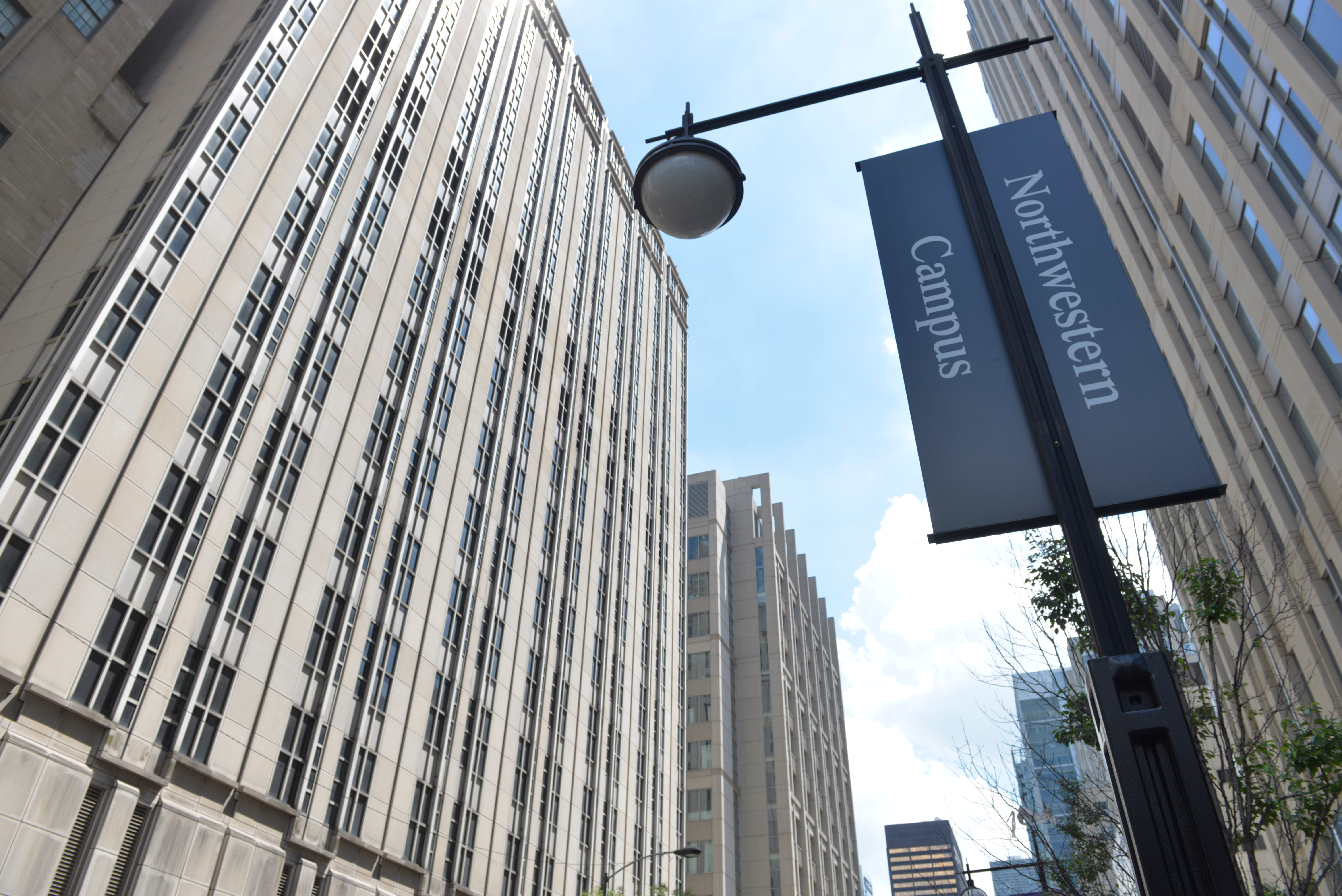 Northwestern's Chicago campus, tall buildings and light post with university banner